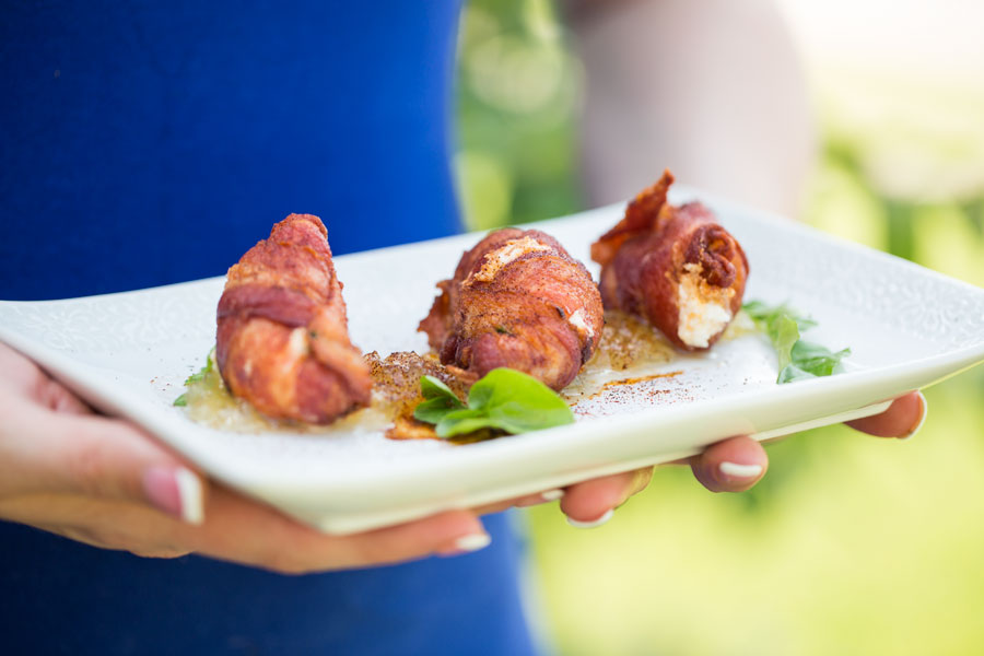 A woman displaying Texas shrimp kisses arranged attractively on a plate