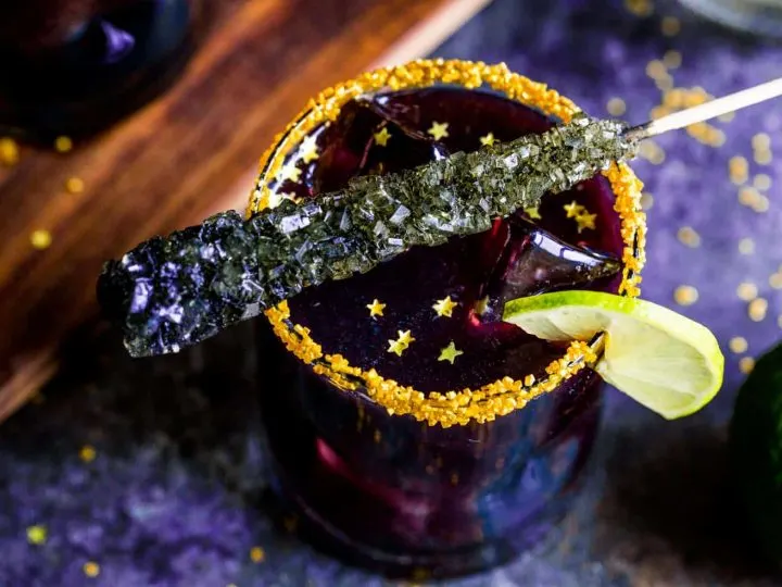 Black Margaritas Recipe - close up with rock candy and gold stars