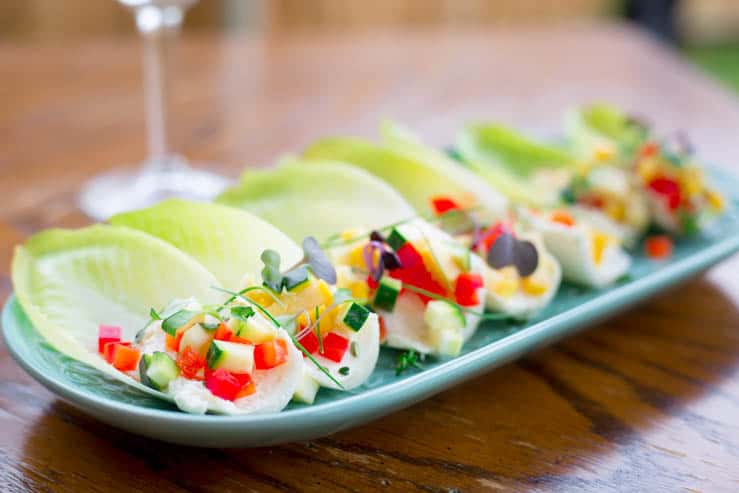 Spring Endive Bites With Boursin Cheese outdoors on a wooden table