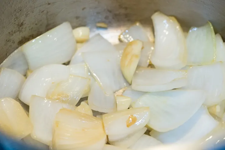 Onions and garlic being sauteed for Texas escabeche 