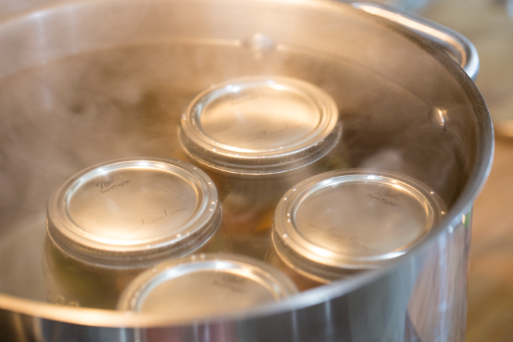 Escabeche being canned in mason jars 