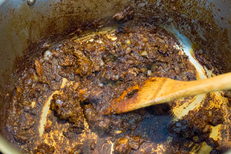 Onions and spices in the pot of brisket chili