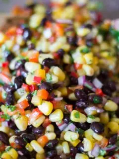 Corn and Black Bean Salad with Mexican Vinaigrette being tossed