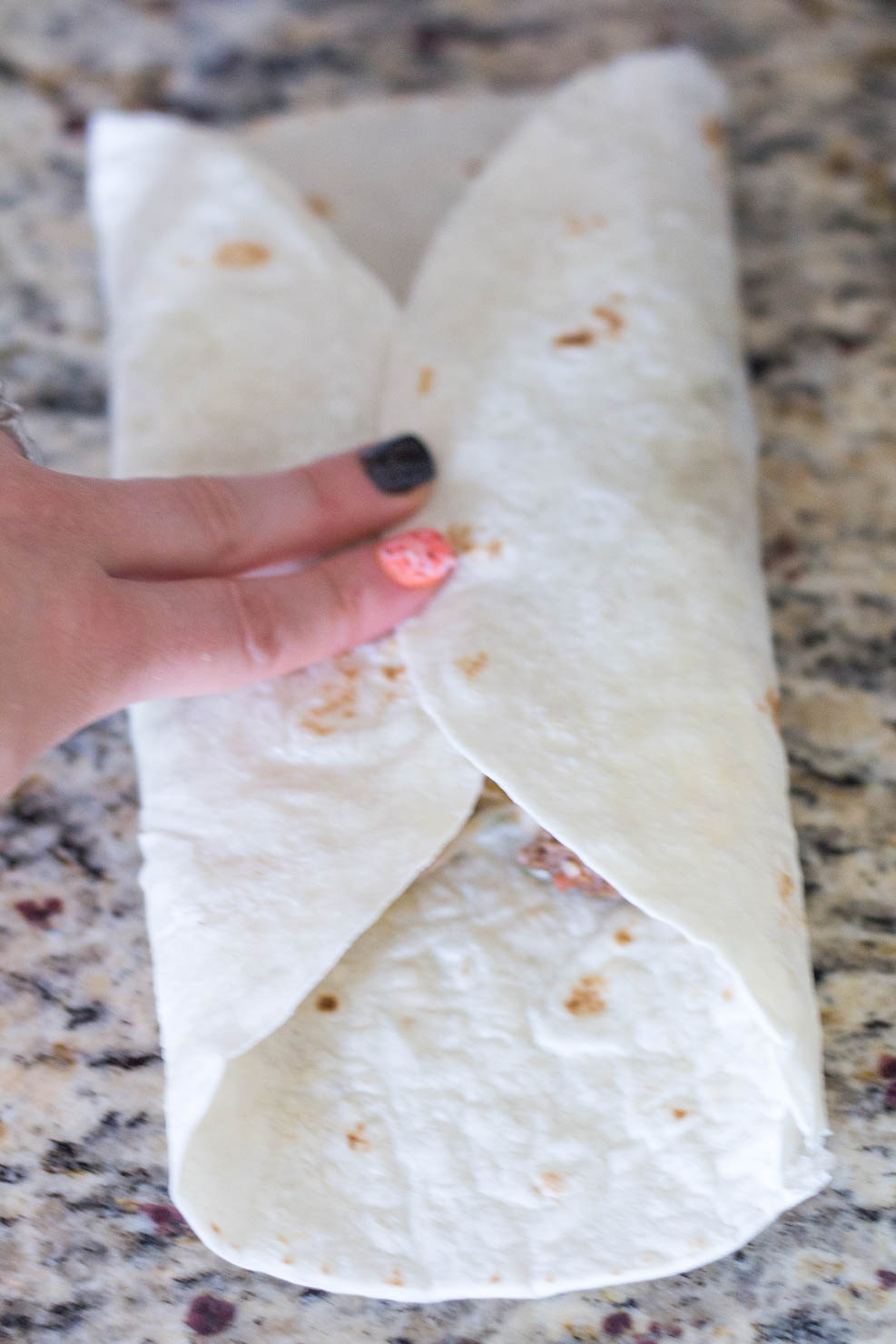 Rolling the baked chimichangas - Step 1