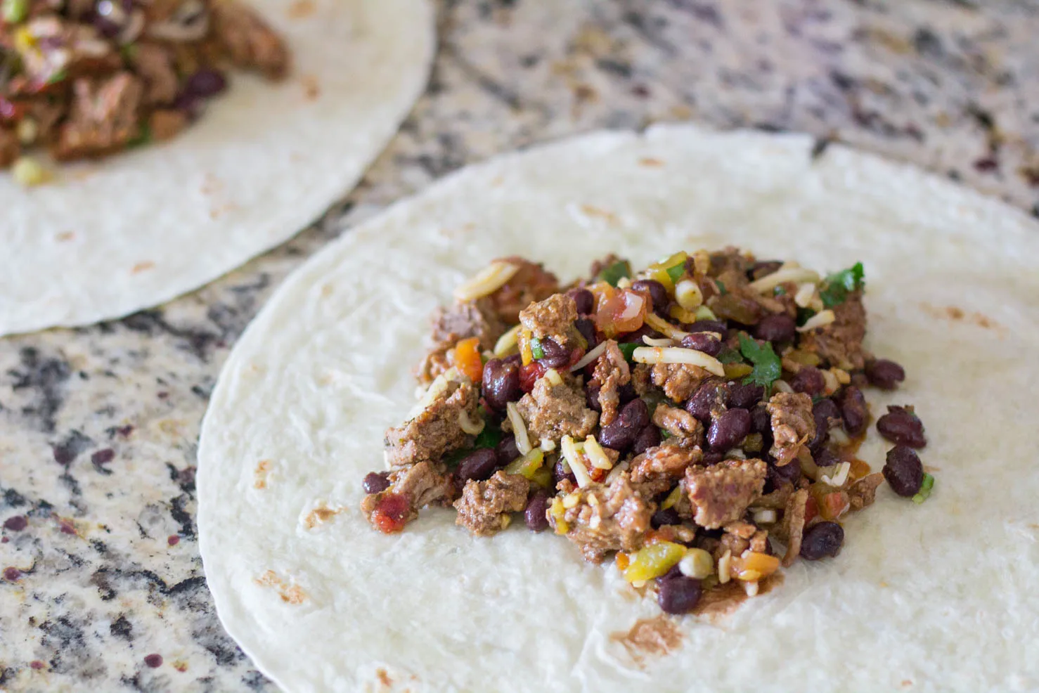 Filling on tortillas for baked chimichangas