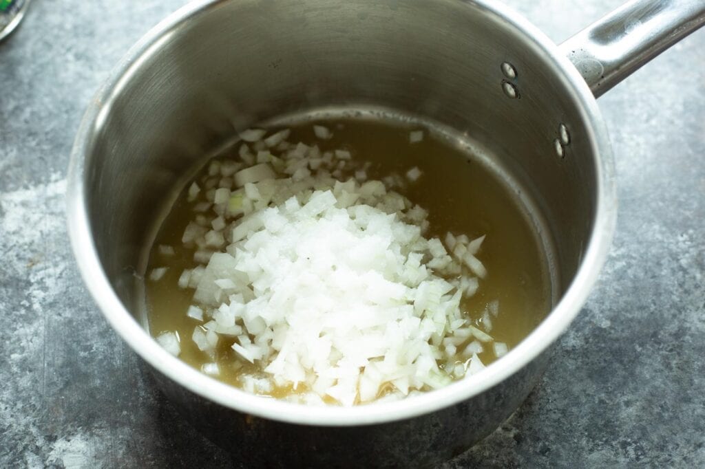 A pan of onion and garlic for the bacon fat refried beans