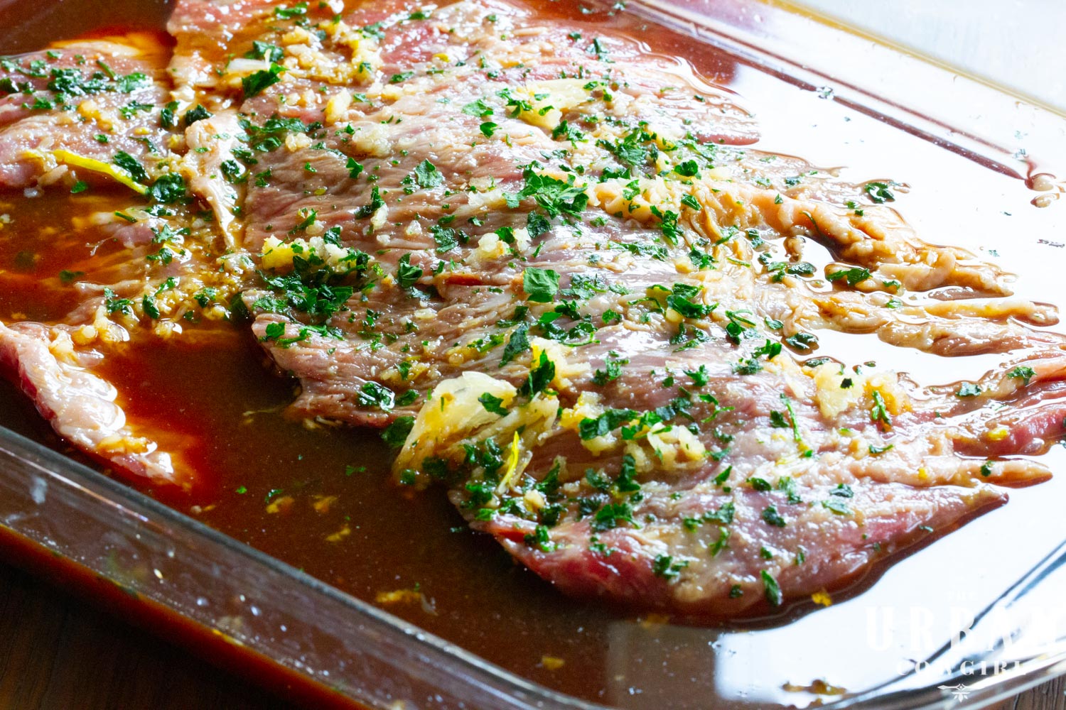 marinaded beef in a casserole dish with marinade