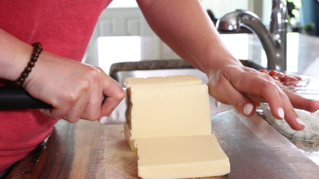 Cutting up white american cheese for the queso blanco dip