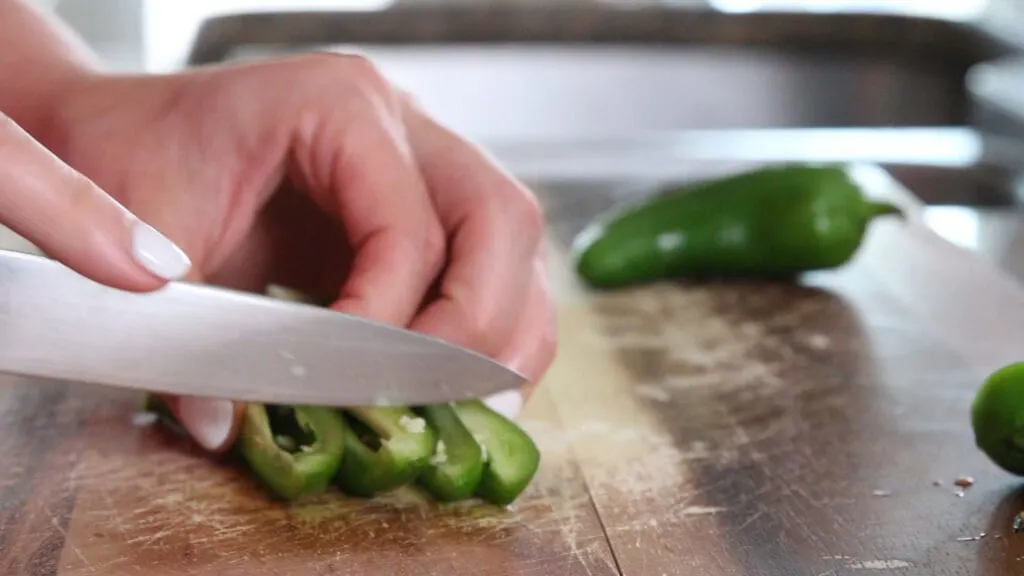 Jalapenos being chopped fine for texas style queso