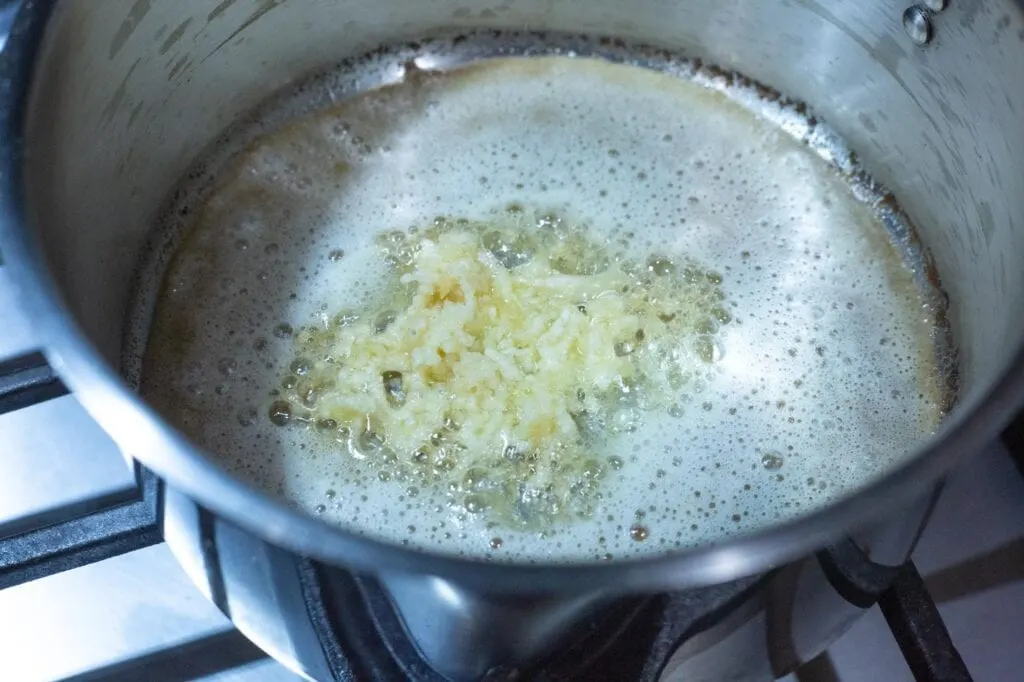 Garlic in melted butter for the white sauce recipe 