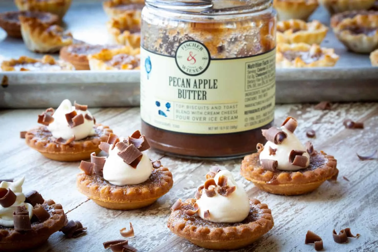 A jar of Apple Butter with Tartlets surrounding it
