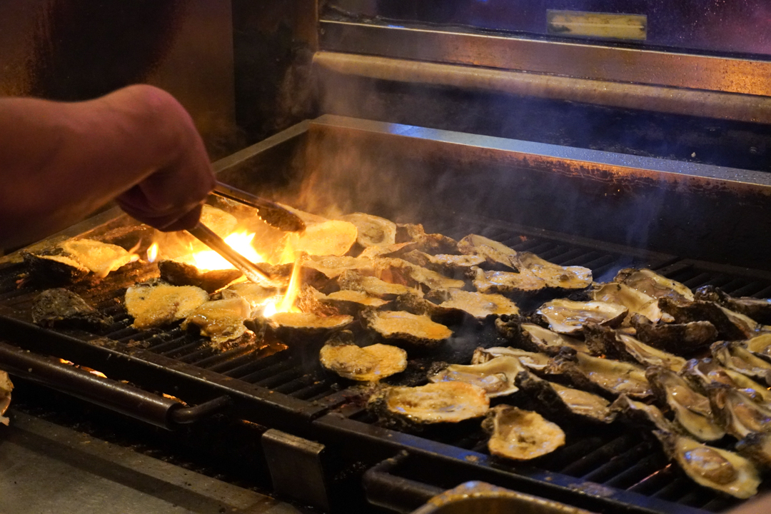 Man grilling oysters in the French Quarter