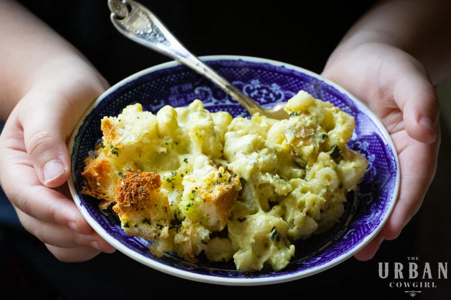 Poblano Mac and Cheese in a bowl with a little child 