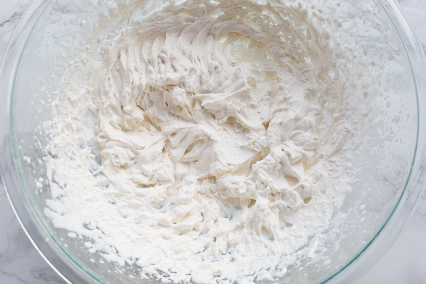 A bowl of nutmeg whipped cream, chilled.