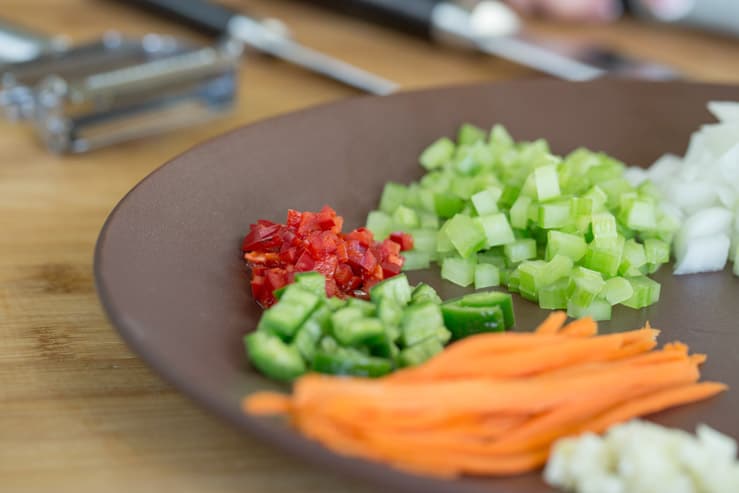 A colorful plate of vegetables chopped precisely 