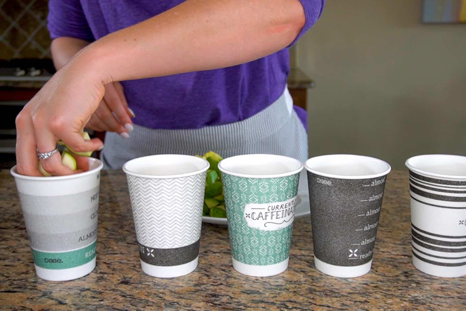 Cups being filled with zucchini 