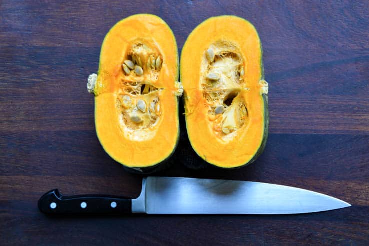 a kabocha squash cut in half by a wustoff chef knife 