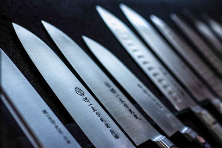 An array of Japanese knives with traditional lettering 