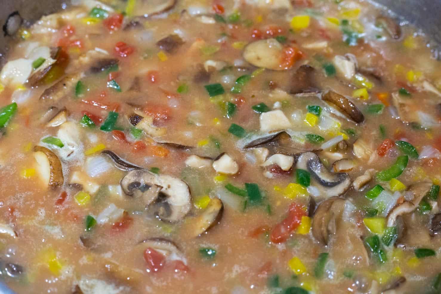 A sauce pan full of the vegetables and thickened chicken stock. Rotel just added. 