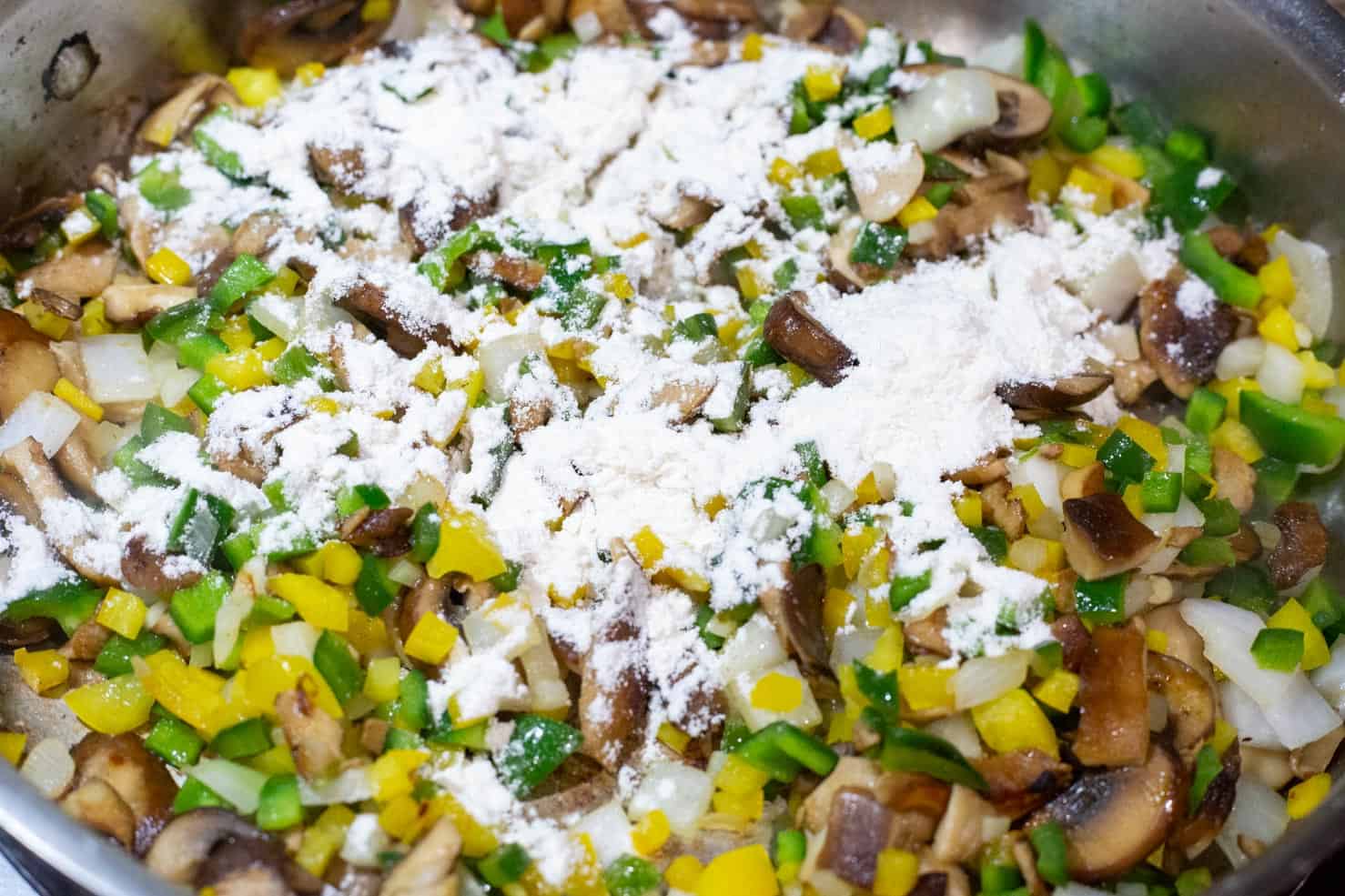 Sauteed poblano, yellow bell pepper, onion, and sprinkled with flour.