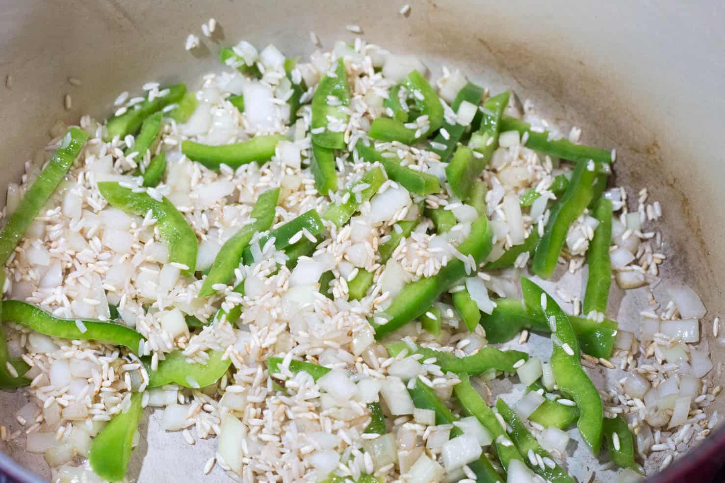 Onion and green bell pepper fried in oil with long grain rice.