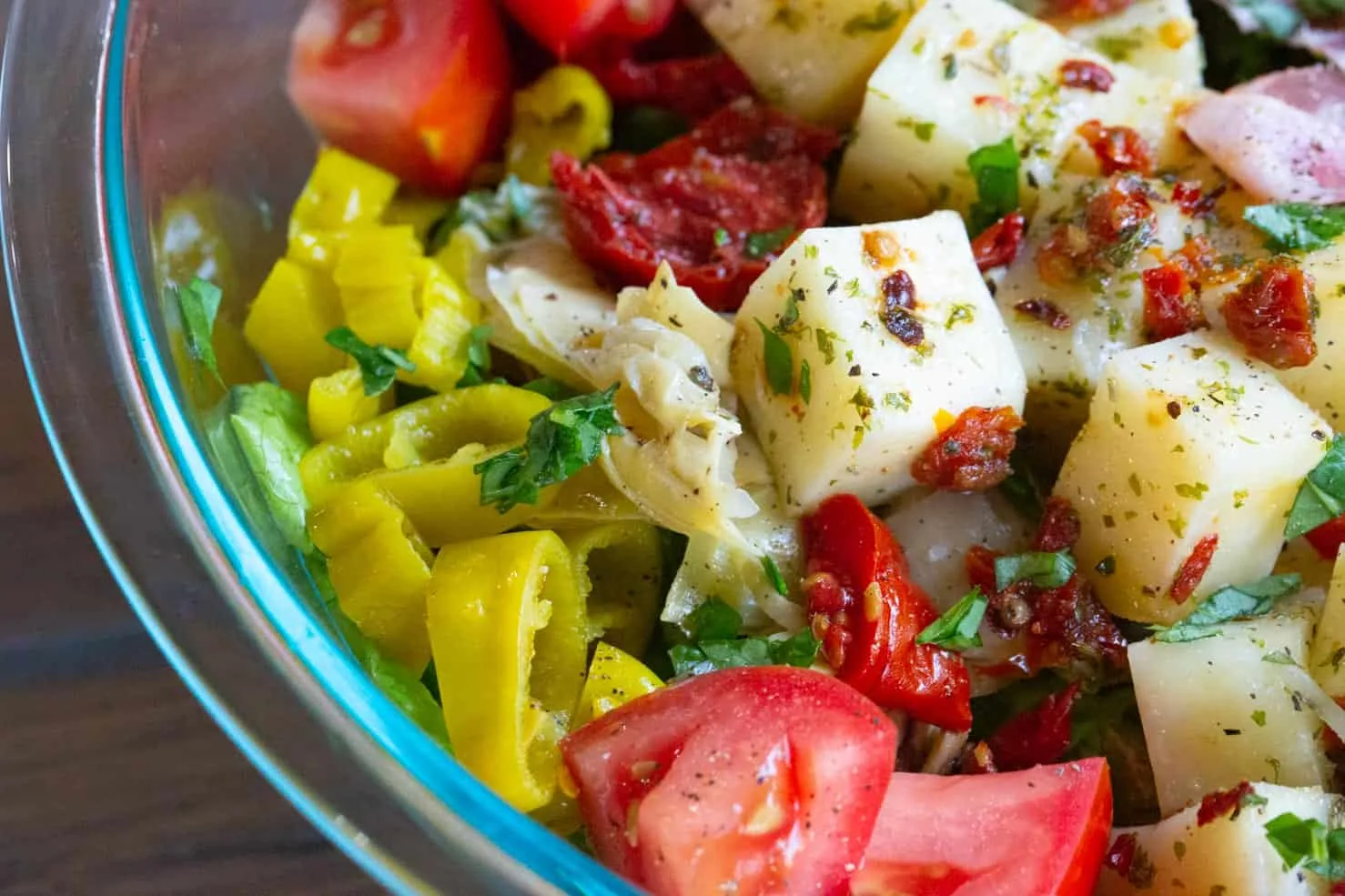 A close up of juicy marinated mozzarella atop the antipasto salad.