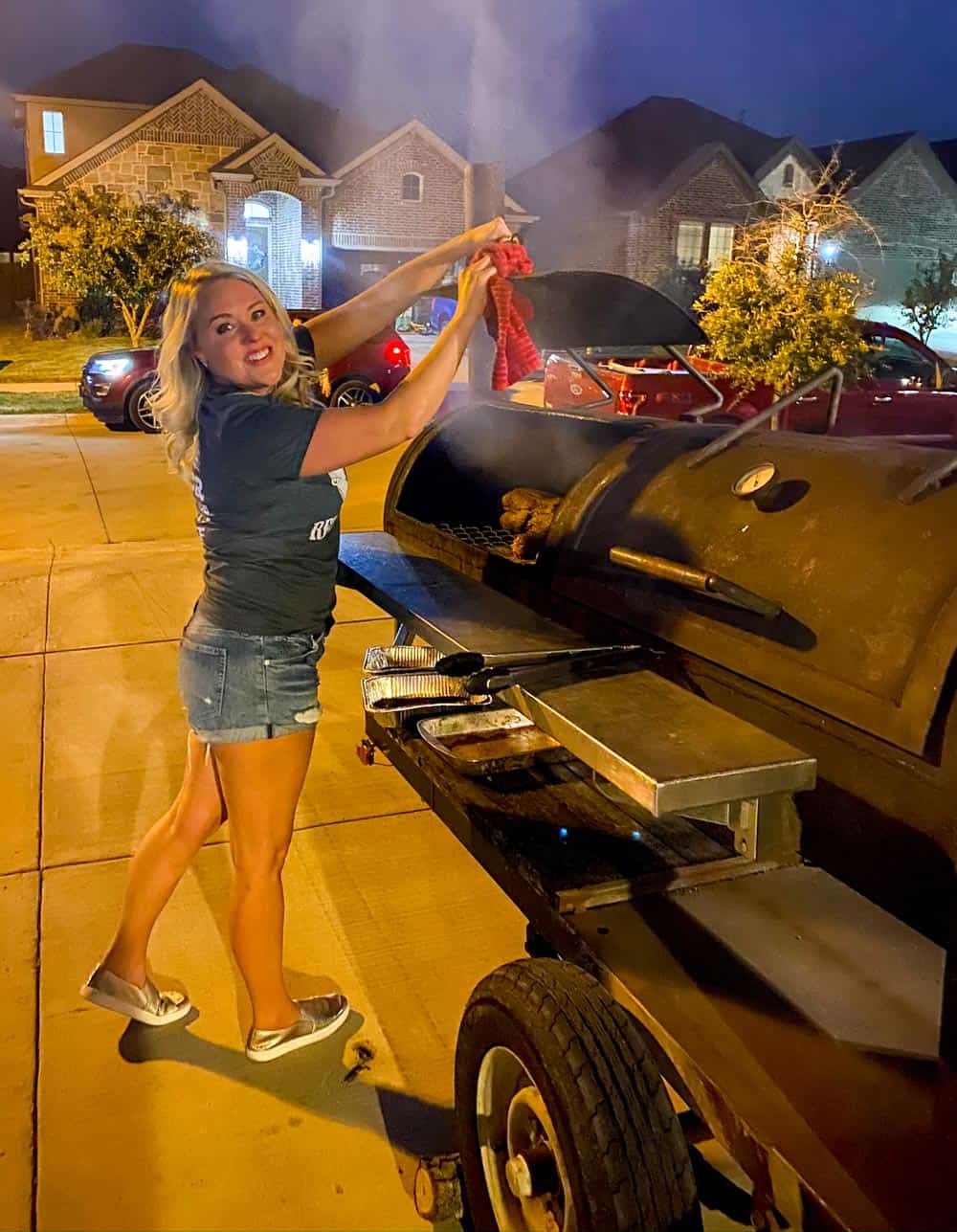 Chef Sarah closing the smoker lid.