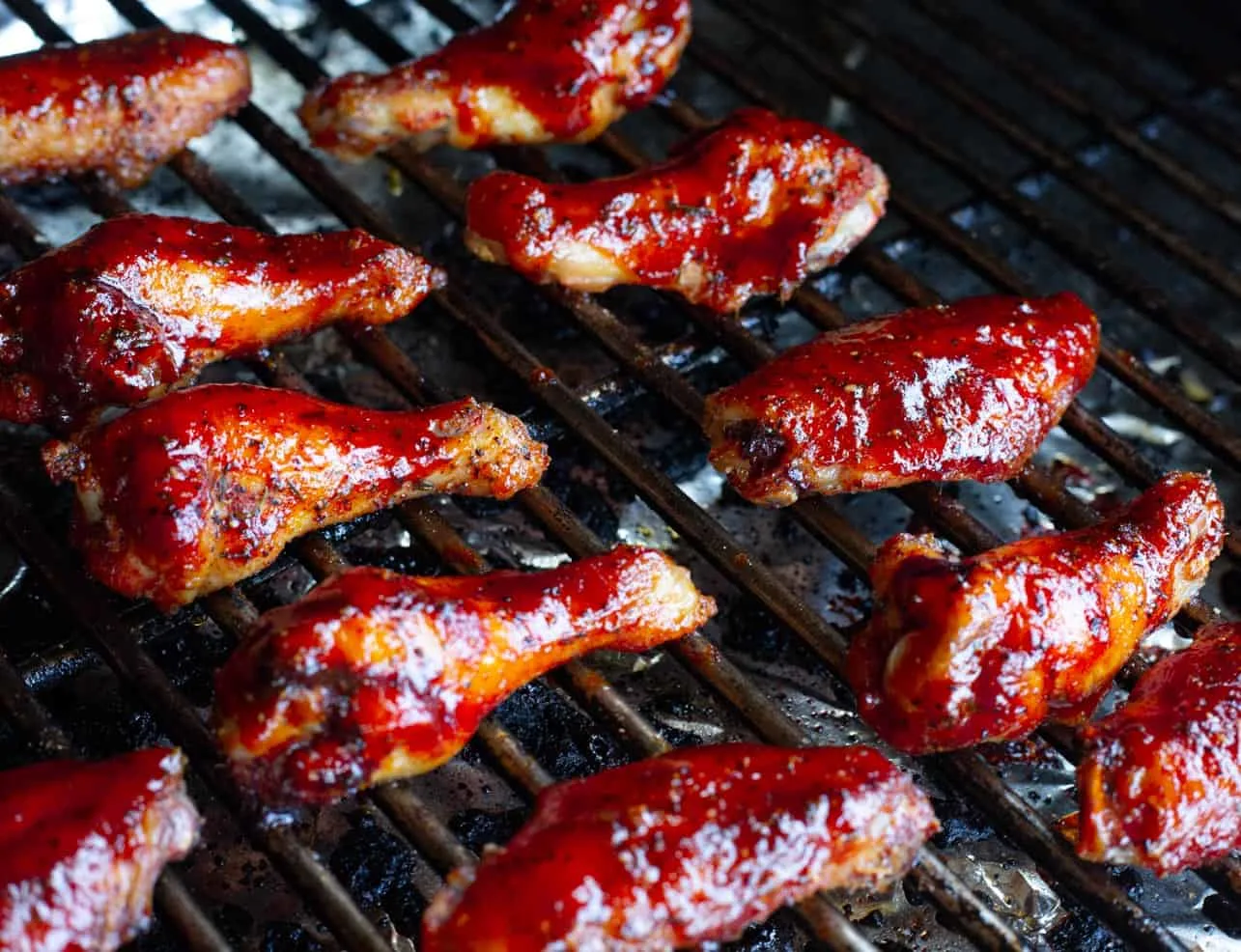 Smoked strawberry barbecue chicken wings on the grill.