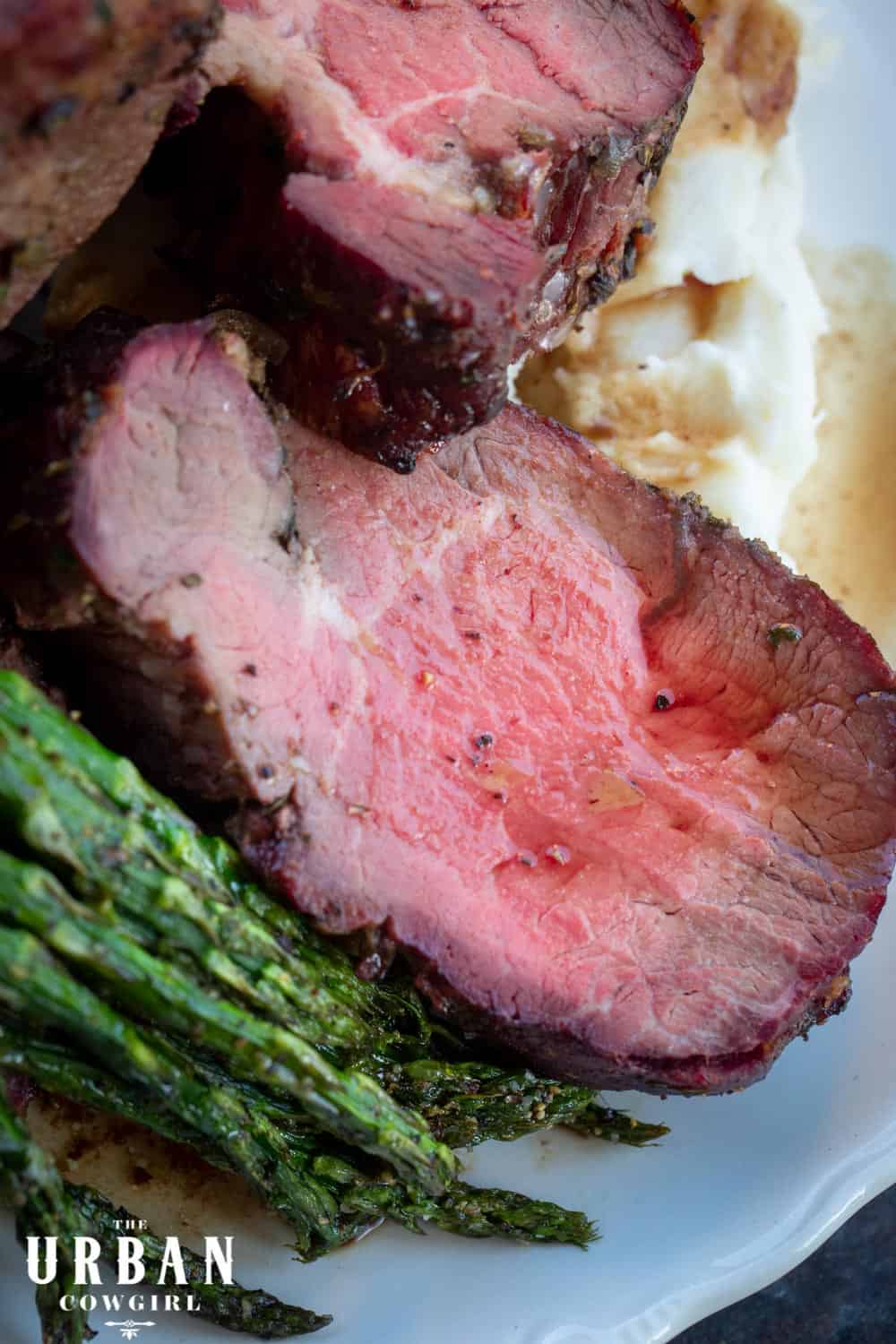 Smoked Beef Tenderloin on a plate of mashed potatoes