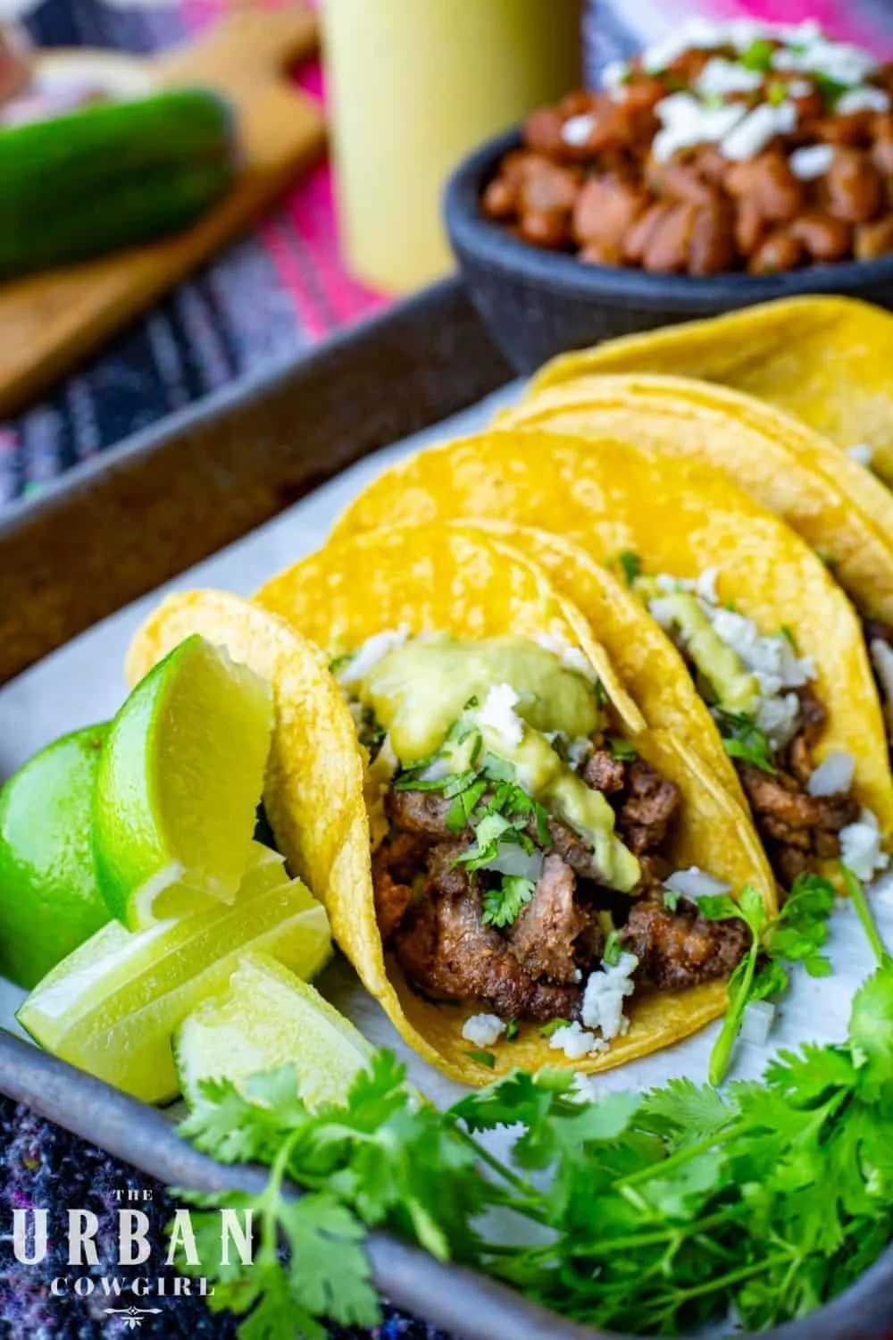 A pan of steak street tacos covered in a creamy jalapeno sauce - close up