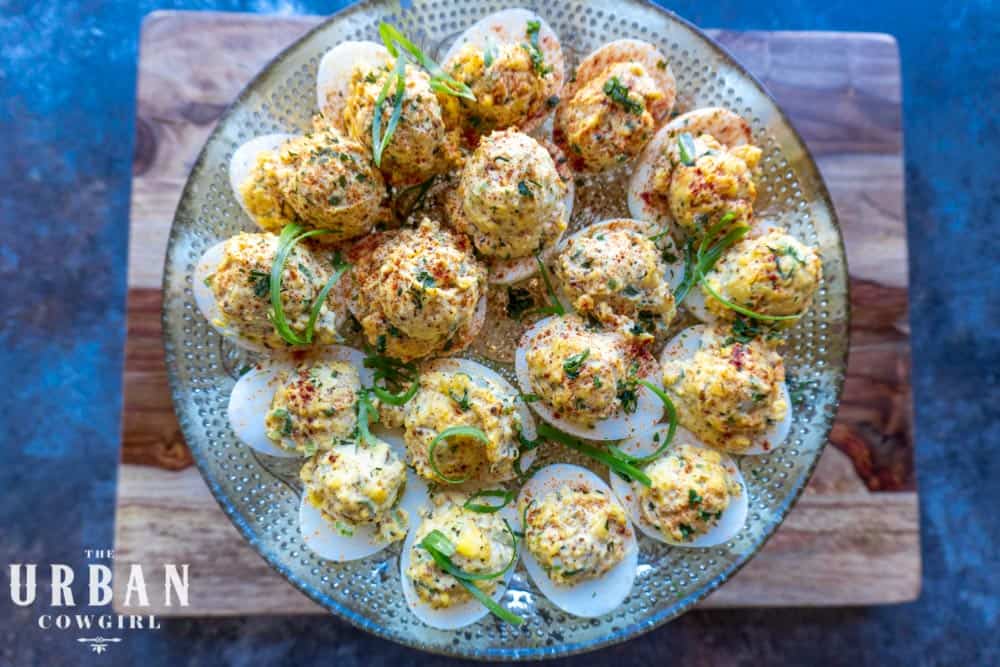 An overhead platter of completed Cajun Deviled Eggs garnished and ready to serve.