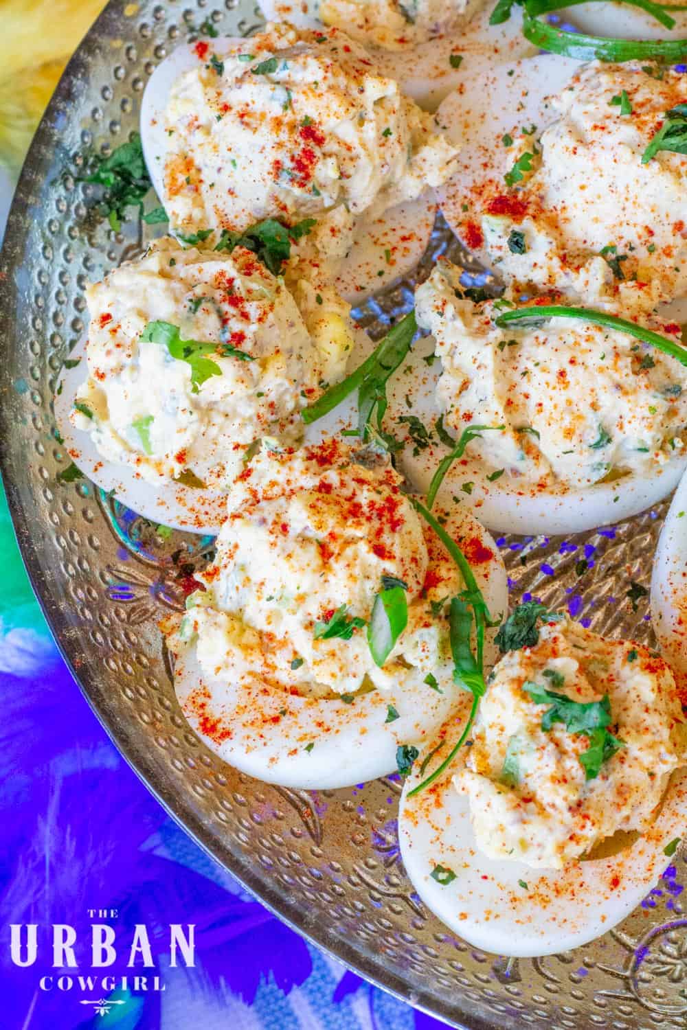 Overhead shot of cajun deviled eggs with a Mardi Gras boa in the background.