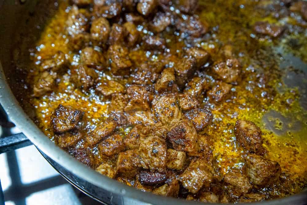 Sizzling steak for street tacos in a pan.