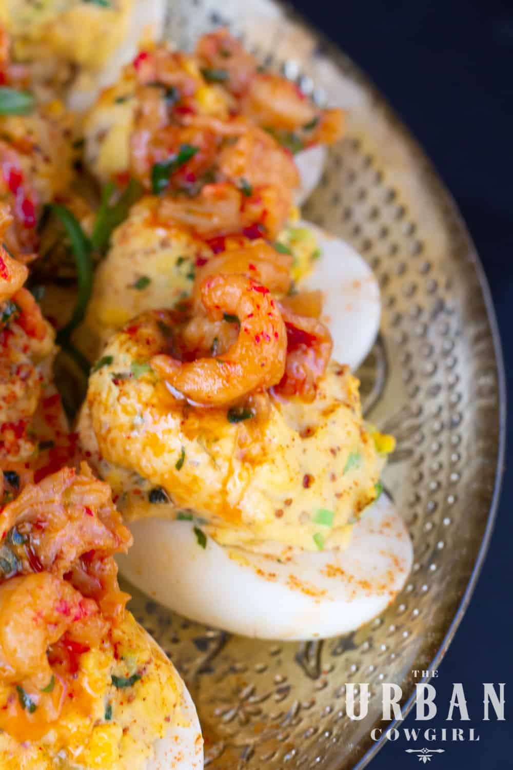 A side profile of crawfish deviled eggs on a party tray.