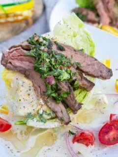 A wedge salad crowned with grilled skirt steak and green chimichurri sauce