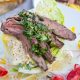 A wedge salad crowned with grilled skirt steak and green chimichurri sauce