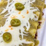 Green Enchiladas with Ground Beef Filling in a White dish.