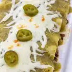 Green Enchiladas with Ground Beef Filling in a White dish.
