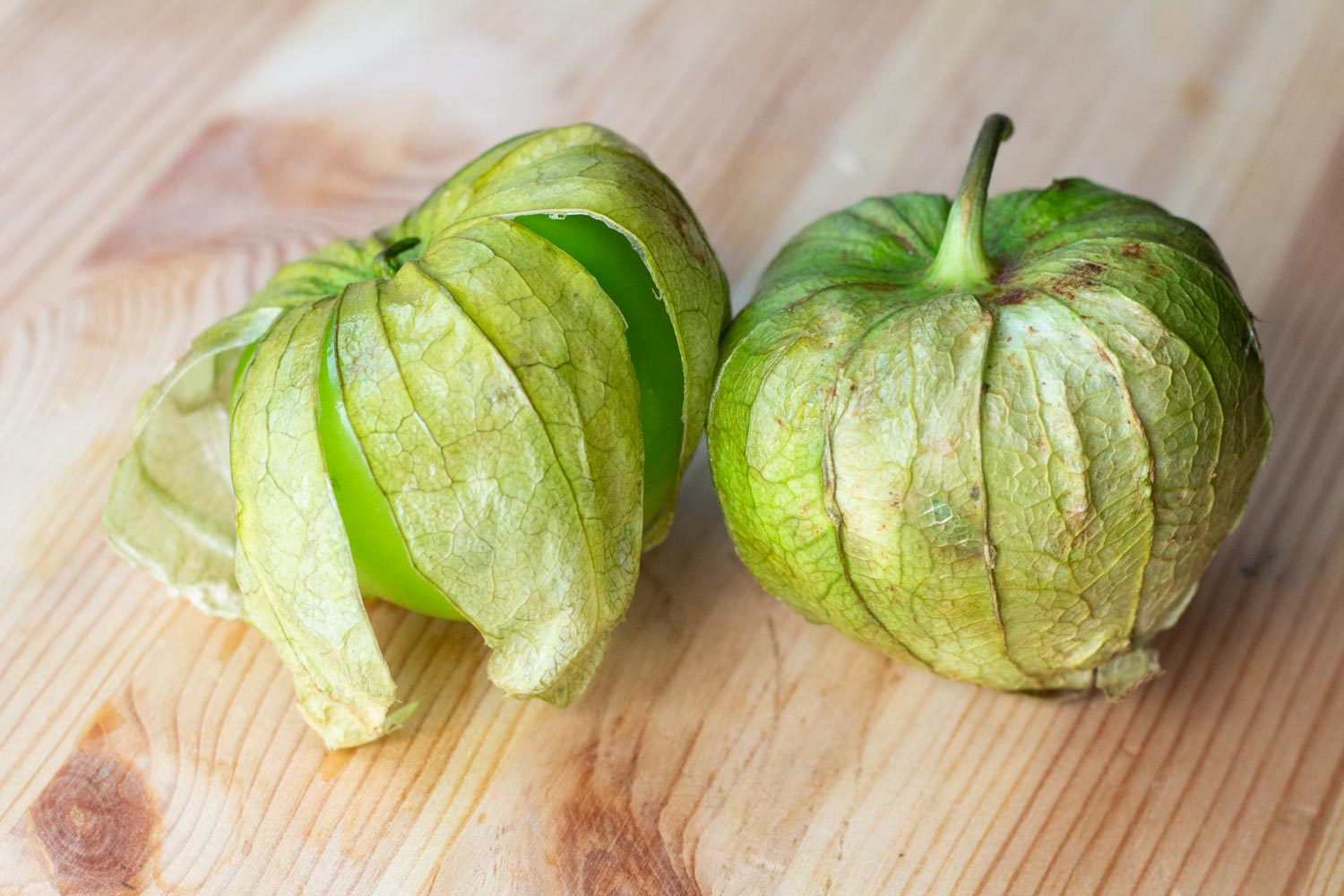 Bright green tomatillos in their husks