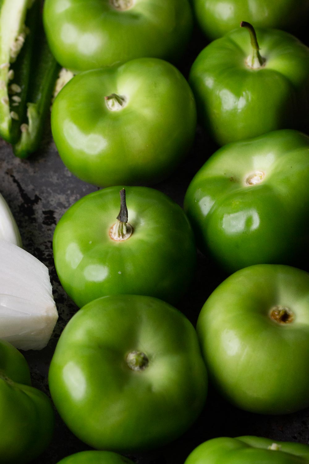 A baking sheet full of raw tomatillos