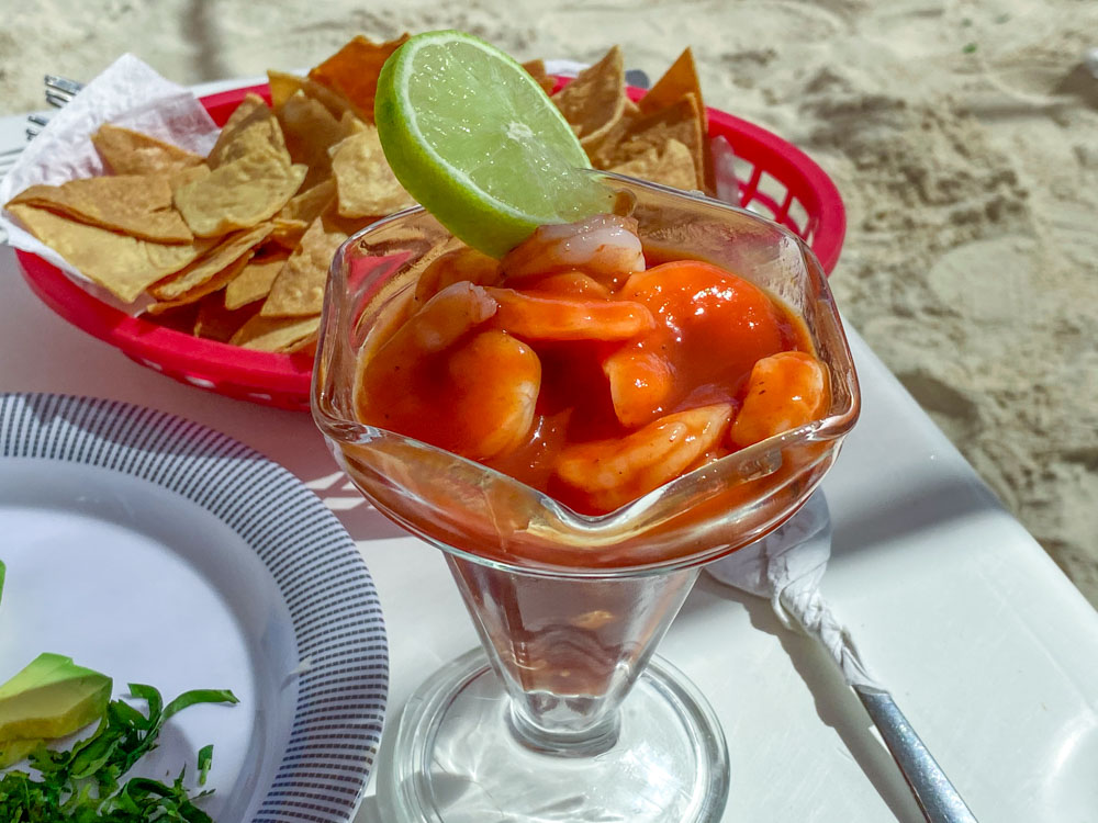 Cocktail de camarones with tortilla chips on the beach.