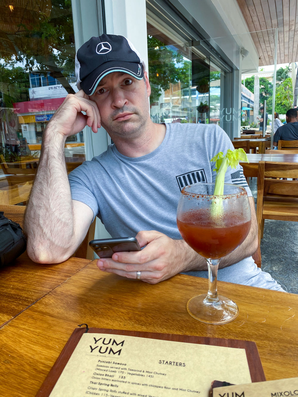 My husband at Yum Yum by George, drinking a Bloody Mary drink