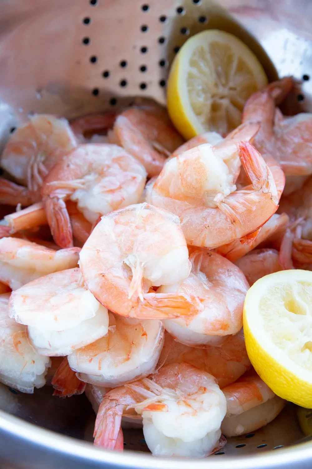 Close up of poached shrimp with the tails falling off