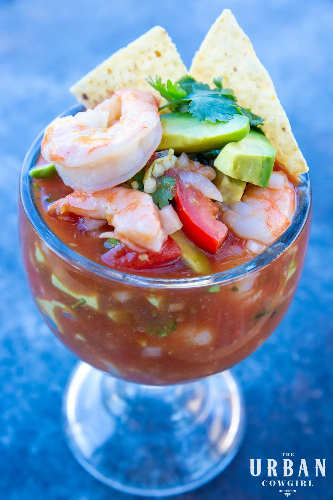 Authentic Mexican shrimp cocktail in a schooner glass, made with mandarin soda, as prepared in Mexico.