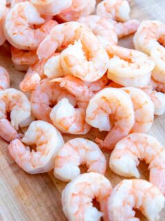 Juicy poached shrimp on a cutting board