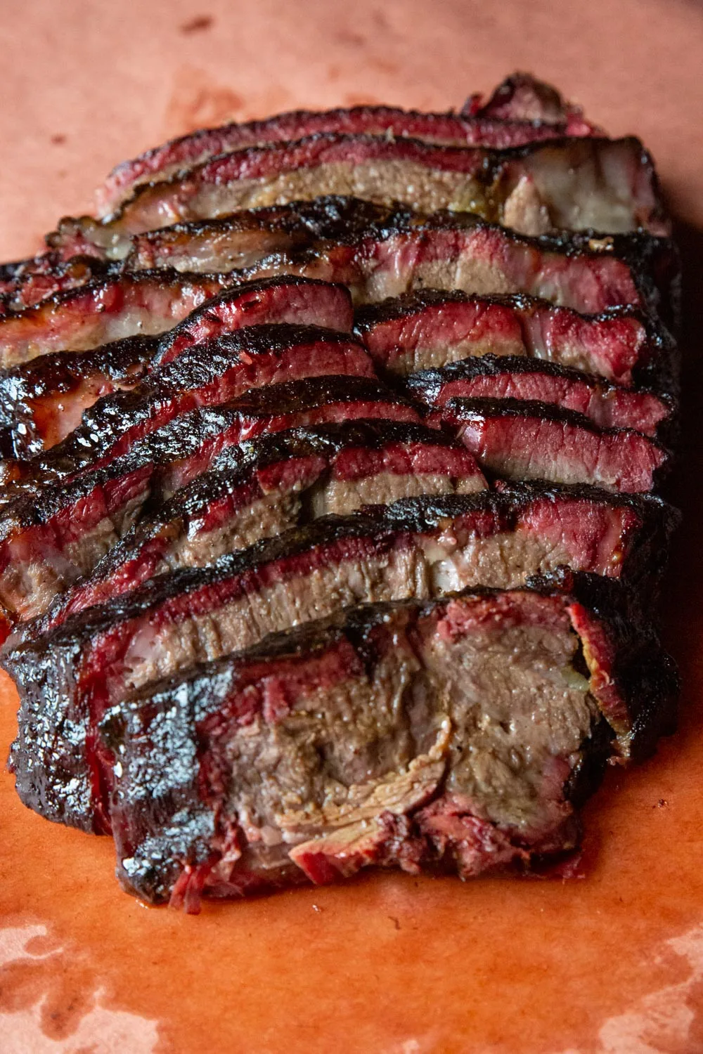 Close up of sliced, ultra juicy smoked chuck roast. Notice the smoke ring and the quality of the bark candy.