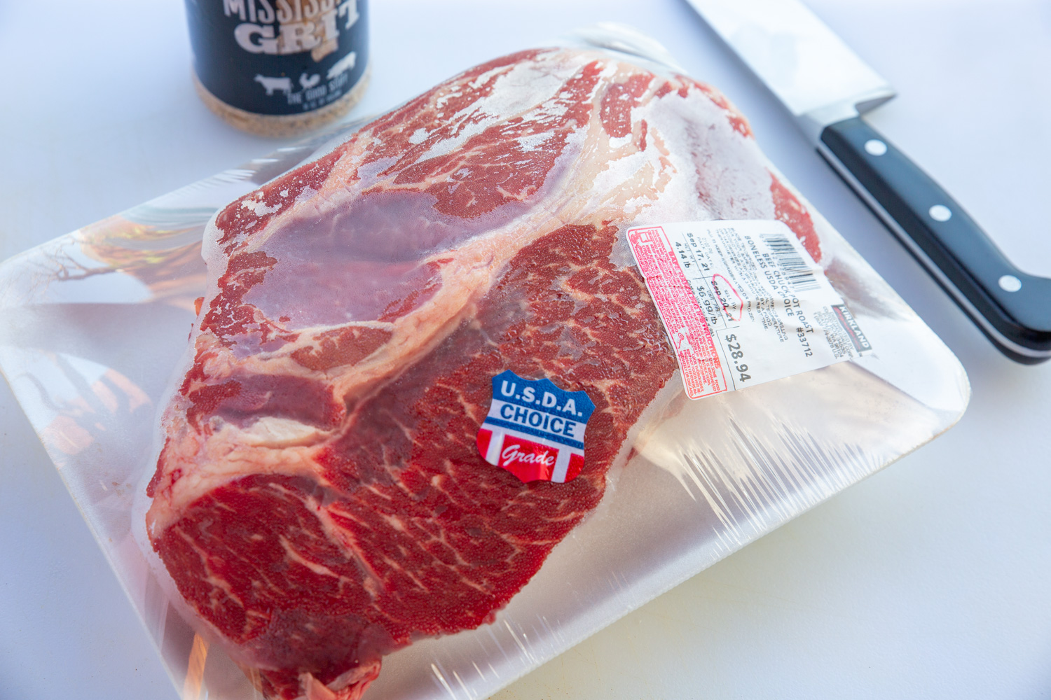 Raw packaged beef chuck roast, in plastic from the grocery store.