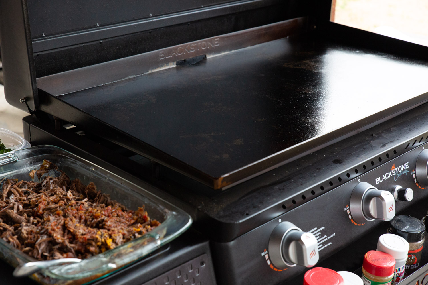 A griddle prepared for frying beef birria tacos.