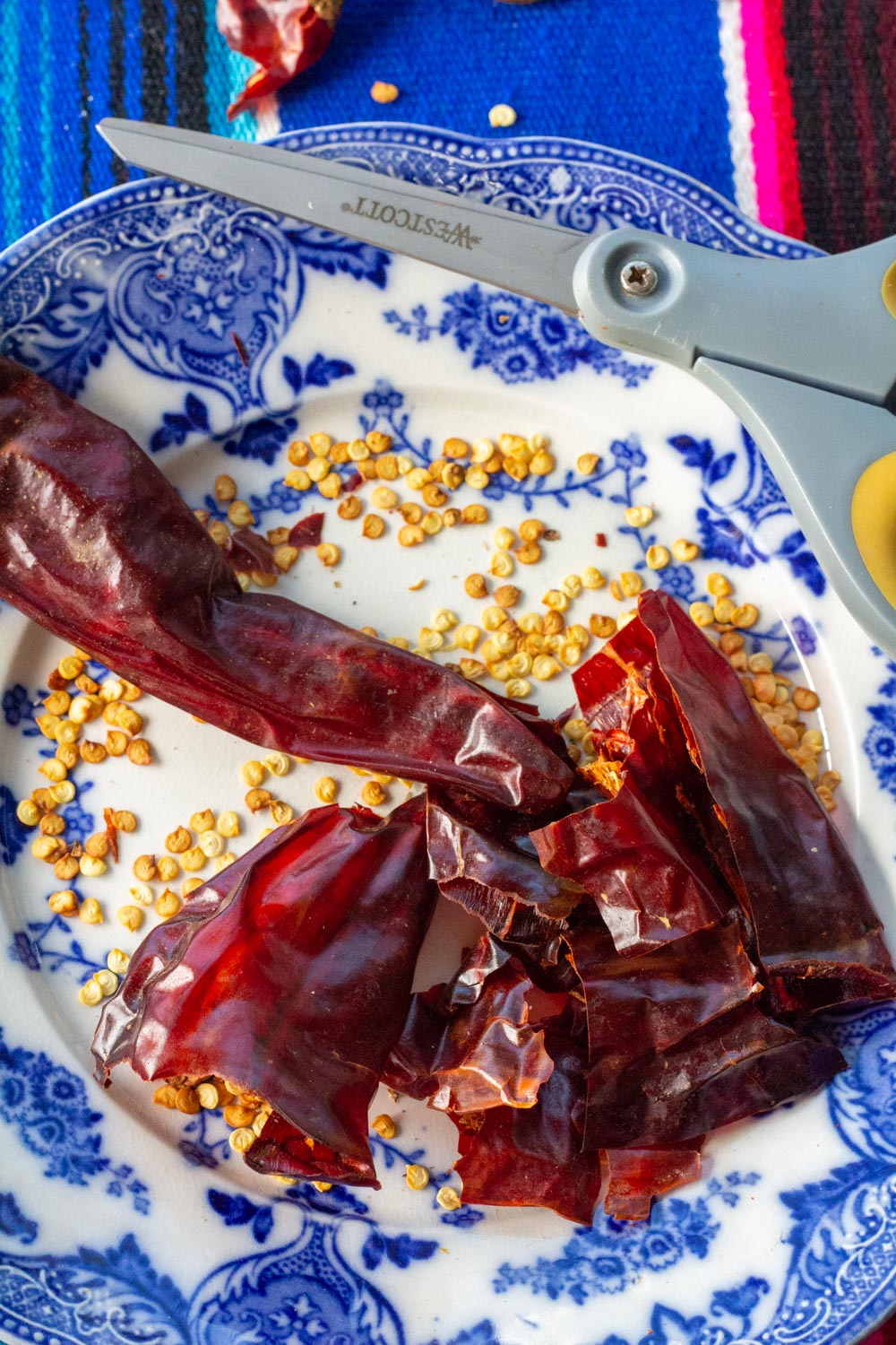 Chiles cut open with scissors and seeds shaken out