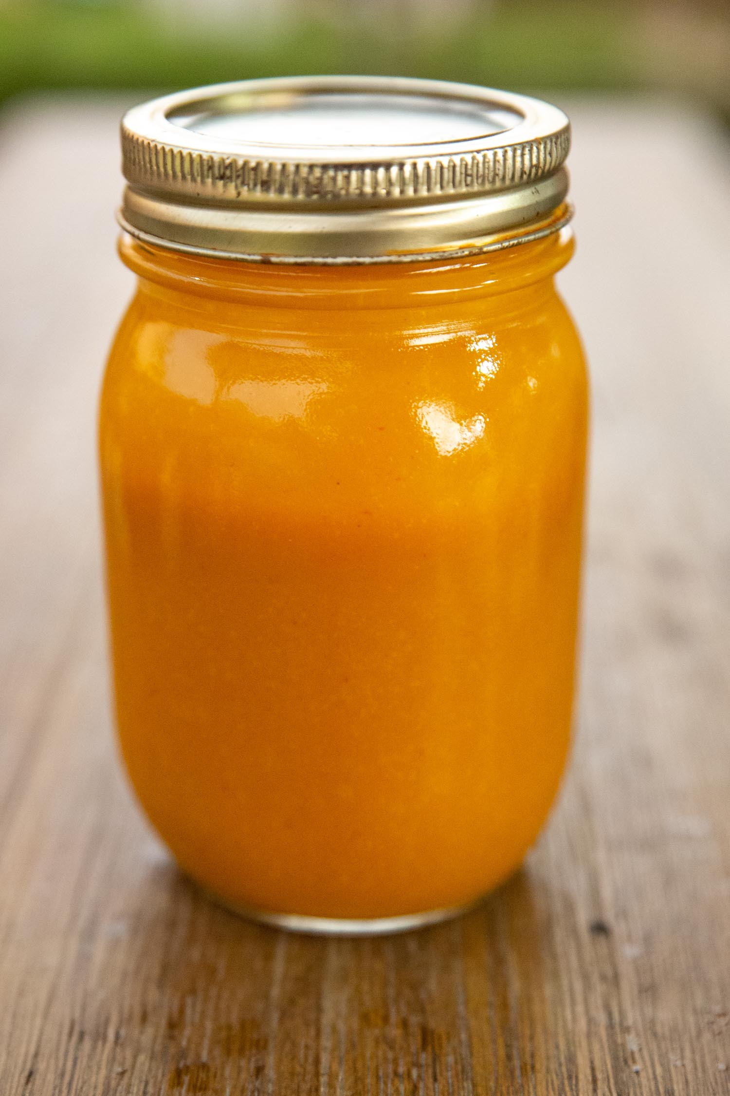 A Mason Jar of Carolina Mustard Gold Barbecue Sauce Sitting on a Tabletop